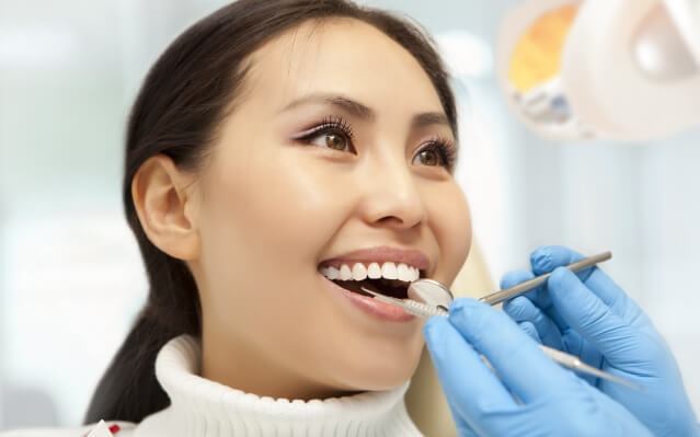Woman receiving scaling and root planing gum disease treatment