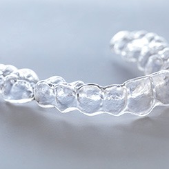 Clear aligner lying on gray surface