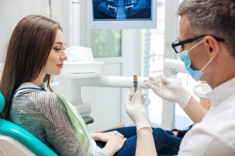 dentist discussing dental implants with female patient